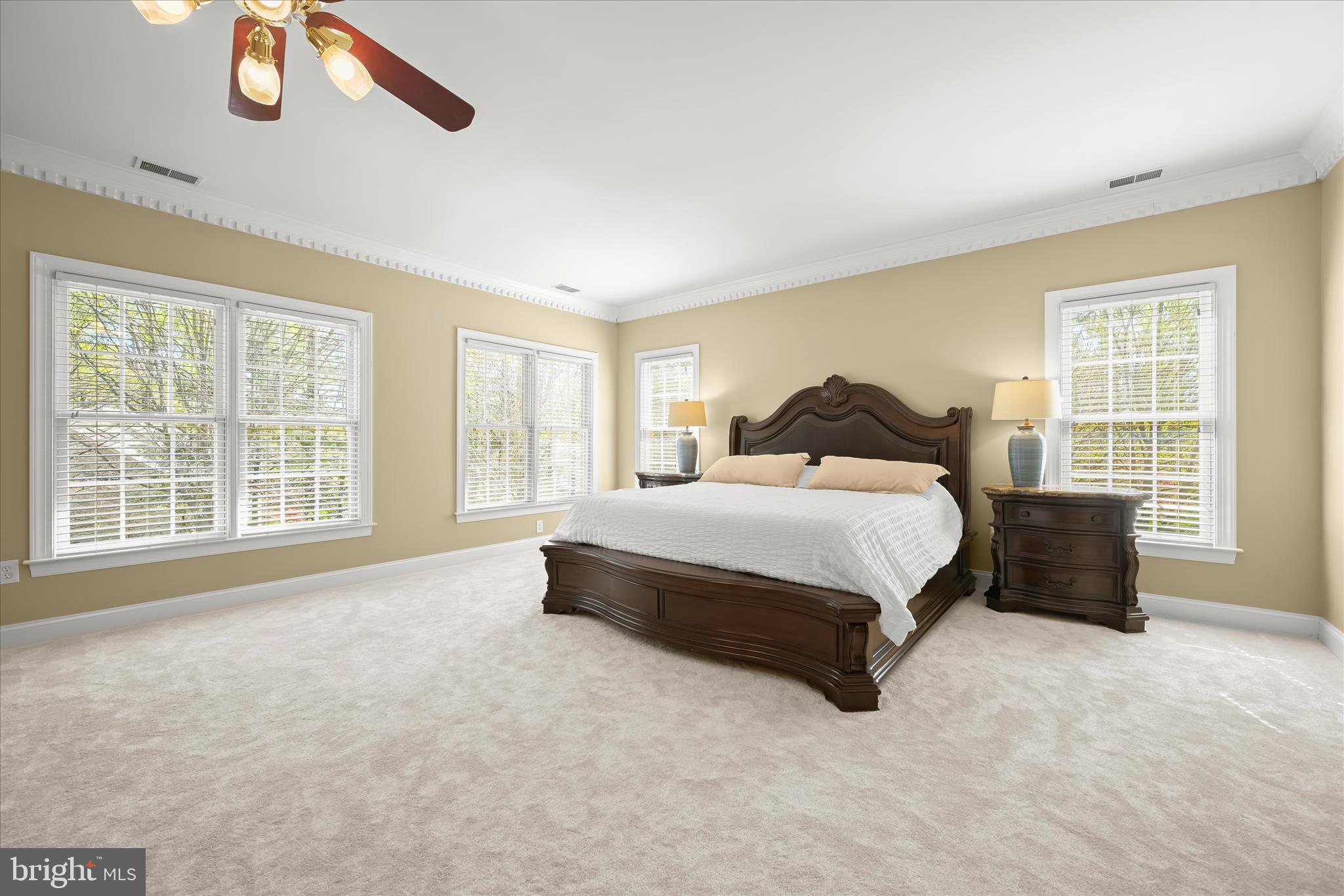 7016 Meandering Stream Way Fulton, MD 20759 - Photo 40 of 86 a spacious bedroom with a bed lamp and a large window