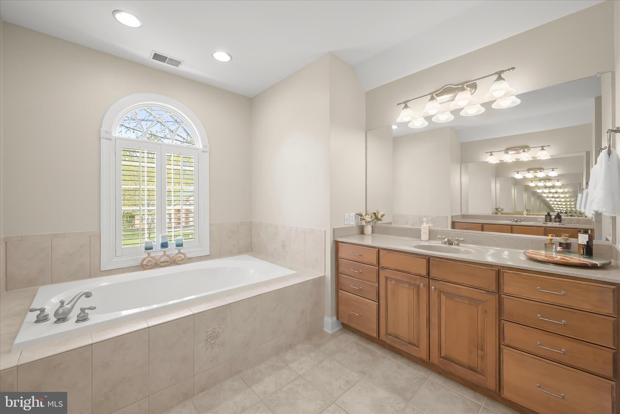 7016 Meandering Stream Way Fulton, MD 20759 - Photo 45 of 86 a spacious bathroom with a large tub sink and vanity