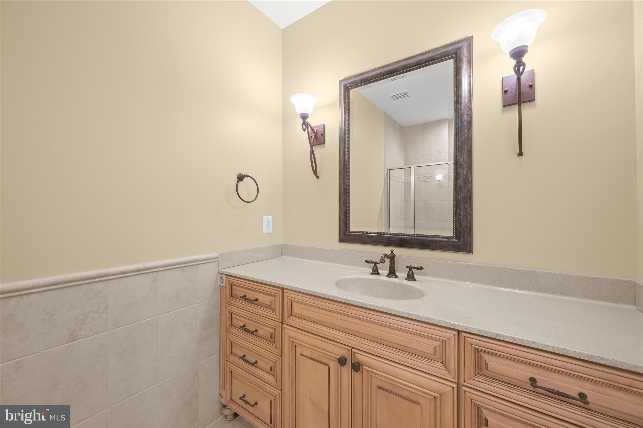 7016 Meandering Stream Way Fulton, MD 20759 - Photo 70 of 86 a bathroom with a sink vanity and a mirror