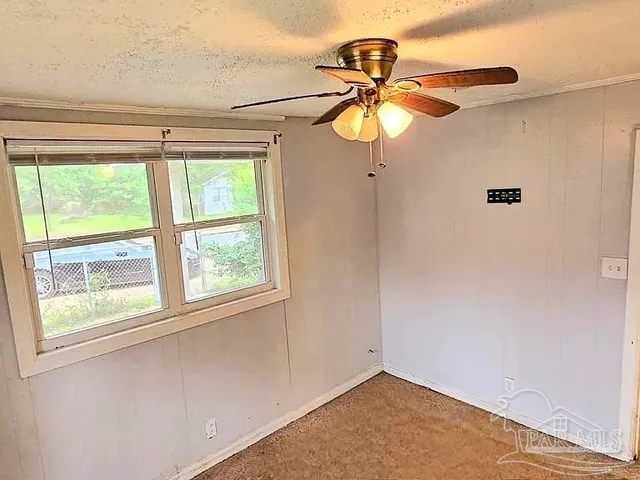 a view of a room with a window and a ceiling fan