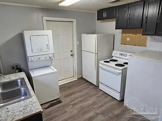a kitchen with a refrigerator sink and stove