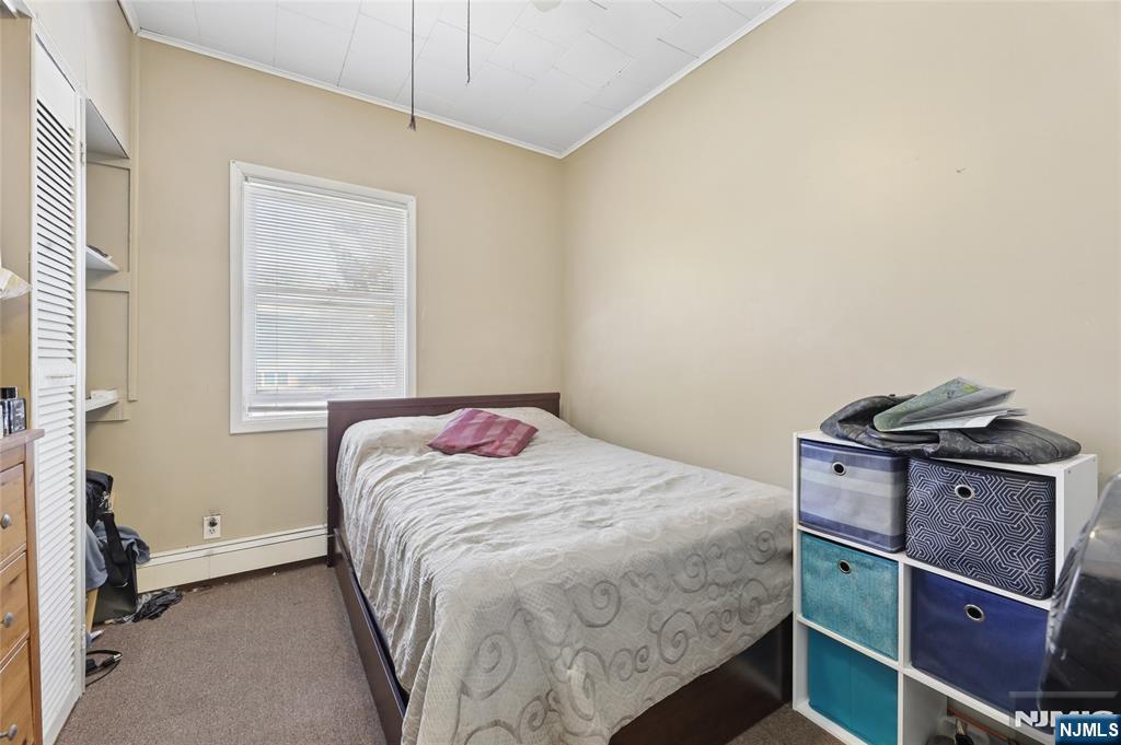 360 Rutherford Boulevard Clifton, NJ 07014 - Photo 16 of 42 a bedroom with a bed and a window