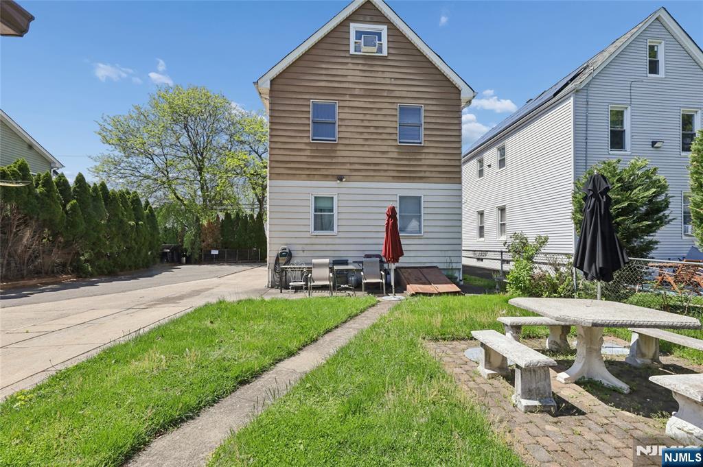 360 Rutherford Boulevard Clifton, NJ 07014 - Photo 17 of 42 a front view of house with yard patio and green space