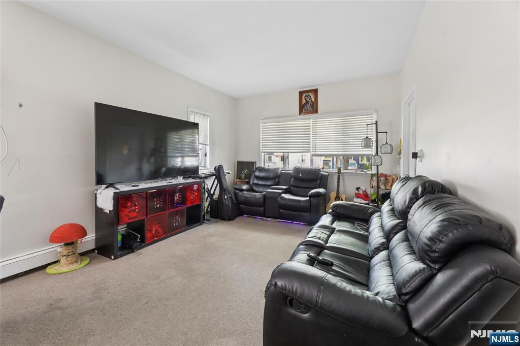 360 Rutherford Boulevard Clifton, NJ 07014 - Photo 24 of 42 a living room with furniture and a flat screen tv