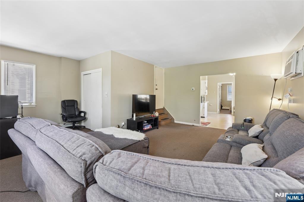 360 Rutherford Boulevard Clifton, NJ 07014 - Photo 3 of 42 a living room with couches and a flat screen tv
