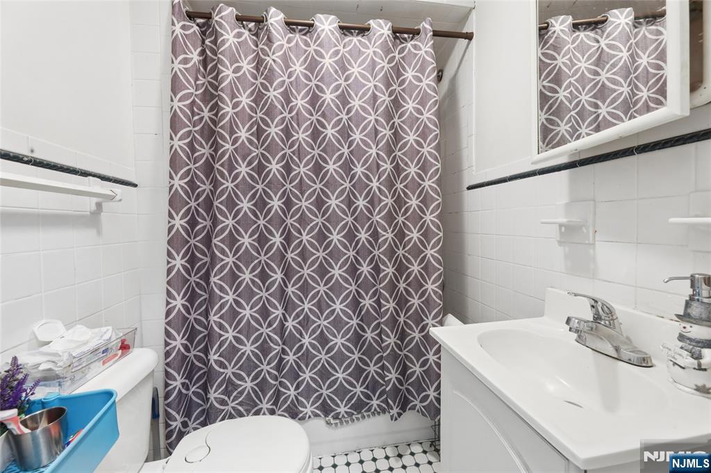 360 Rutherford Boulevard Clifton, NJ 07014 - Photo 32 of 42 a bathroom with a sink toilet and shower