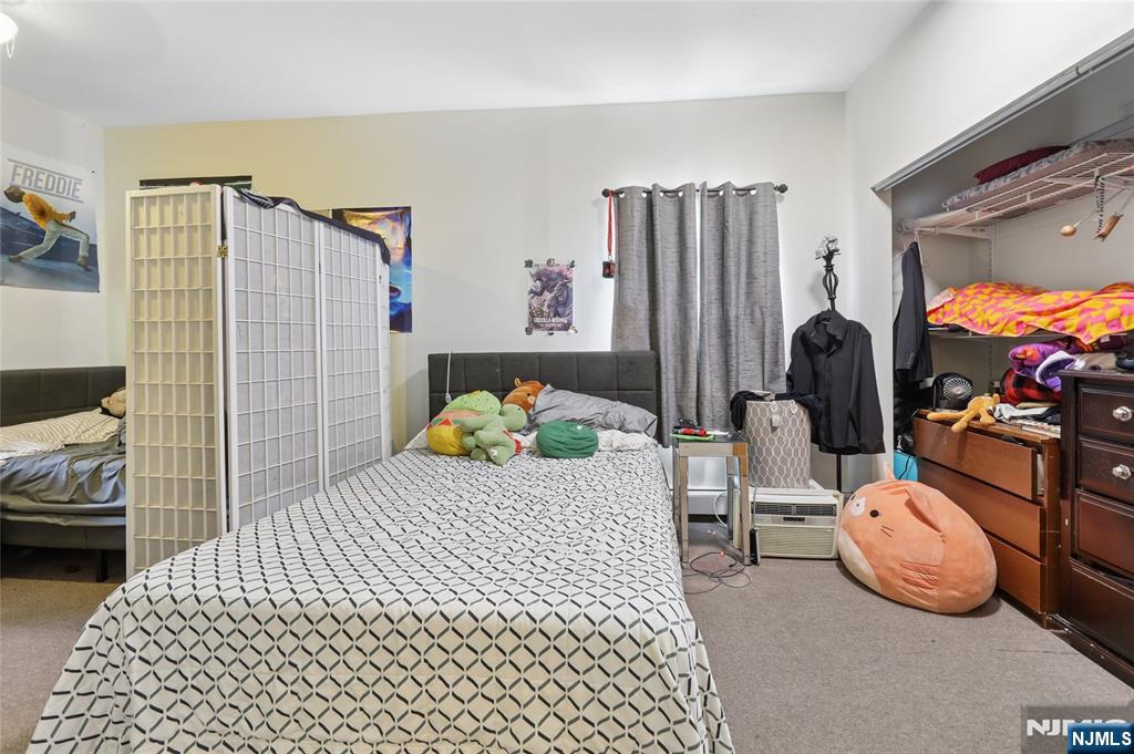 360 Rutherford Boulevard Clifton, NJ 07014 - Photo 33 of 42 a bedroom with a bed and a flat tv screen