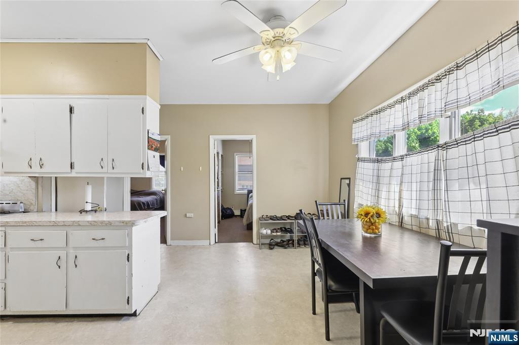 360 Rutherford Boulevard Clifton, NJ 07014 - Photo 40 of 42 a view of kitchen with stainless steel appliances granite countertop a stove a sink a dining table and chairs