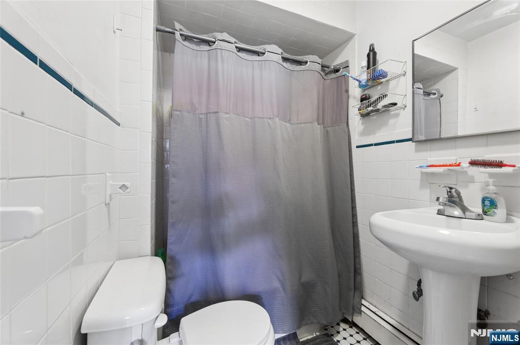 360 Rutherford Boulevard Clifton, NJ 07014 - Photo 6 of 42 a bathroom with a sink toilet and shower