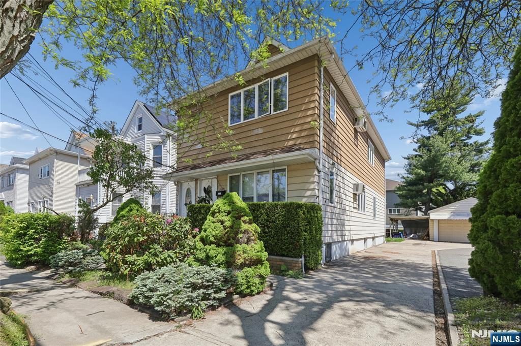 360 Rutherford Boulevard Clifton, NJ 07014 - Photo 8 of 42 a front view of a house with a yard