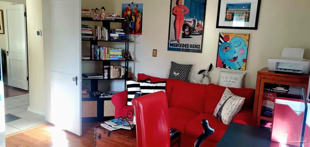 a living room with furniture and book shelf