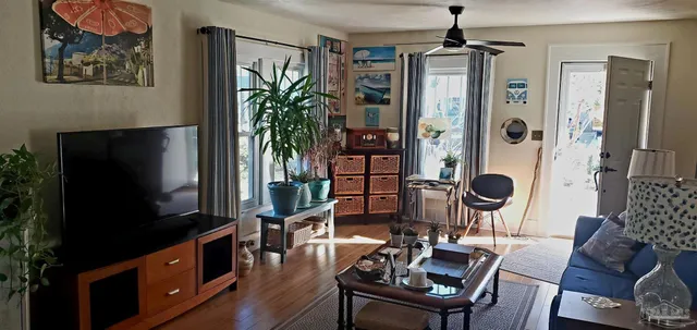 a living room with furniture and a flat screen tv