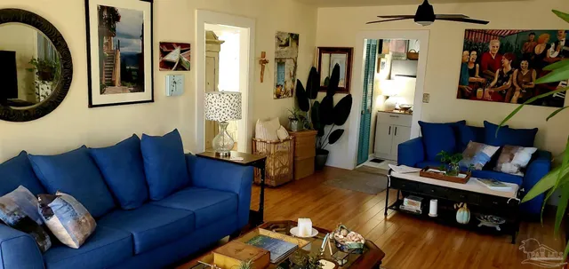 a living room with furniture and wooden floor