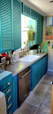 a kitchen with a sink cabinets and a large window