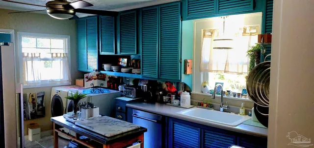 a kitchen with a table chairs and a window