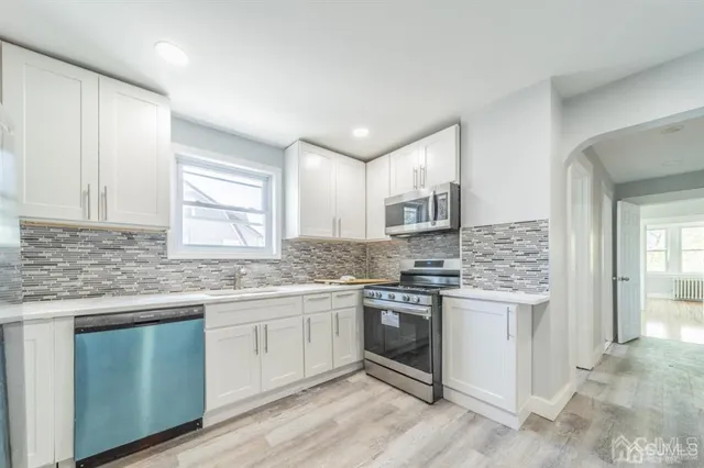 a kitchen with stainless steel appliances granite countertop a stove and a sink
