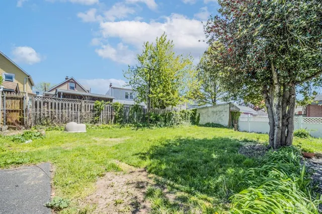 a view of a house with yard and a garden