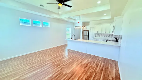 a kitchen with sink a refrigerator and cabinets