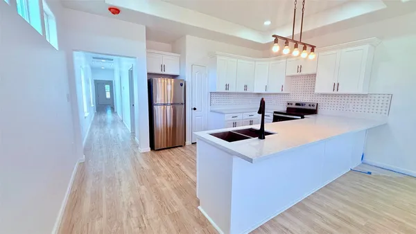 a view of an entryway with wooden floor