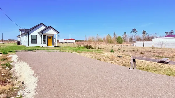 a view of a house with wooden fence