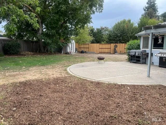 a view of a backyard with sitting area