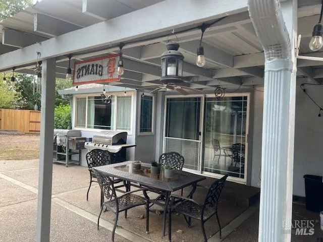 a view of an outdoor dining space with a tv