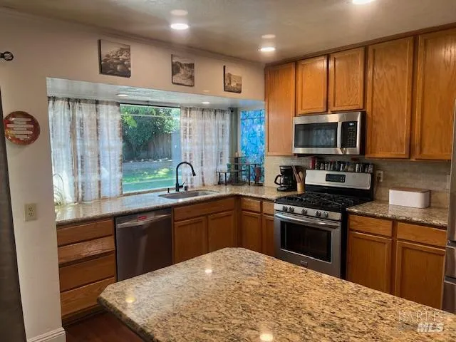 a kitchen with a sink stove top oven and cabinets