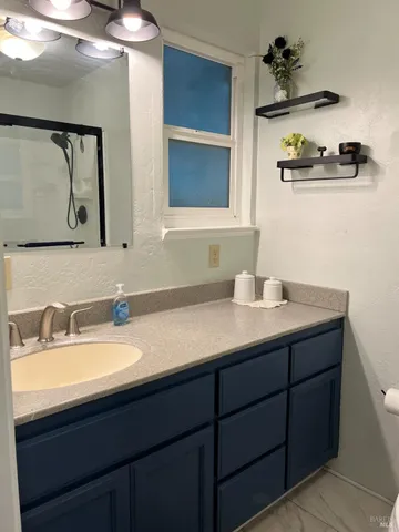 a bathroom with a double vanity sink and a mirror