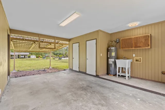 a view of a livingroom with furniture and floor to ceiling window