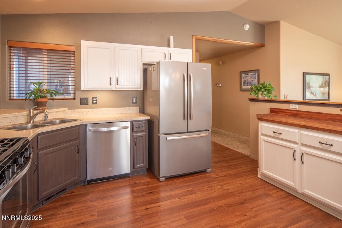 609 Nader Way Fernley, NV 89408 - Photo 13 of 38 a kitchen with a white cabinets and white appliances