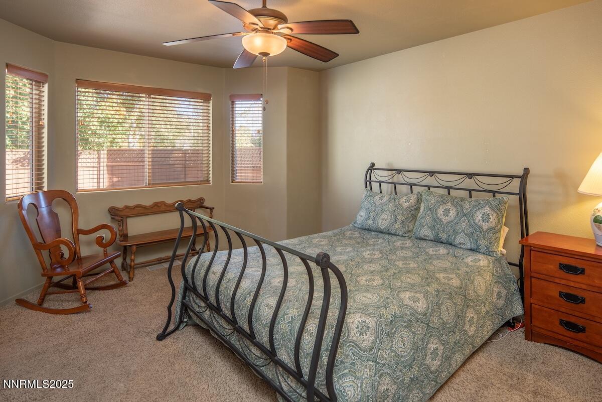 609 Nader Way Fernley, NV 89408 - Photo 17 of 38 a bed sitting in a bedroom next to a window