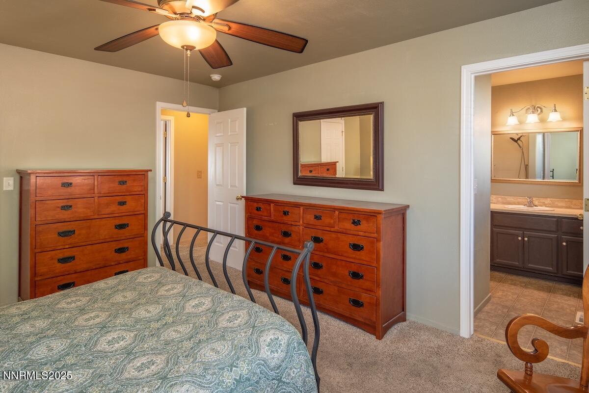 609 Nader Way Fernley, NV 89408 - Photo 19 of 38 a bedroom with a bed and a chandelier