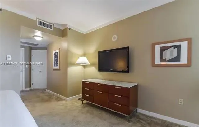 a room with a bed and a flat screen tv