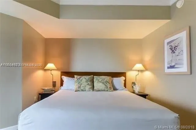 a bedroom with a bed and a night stand