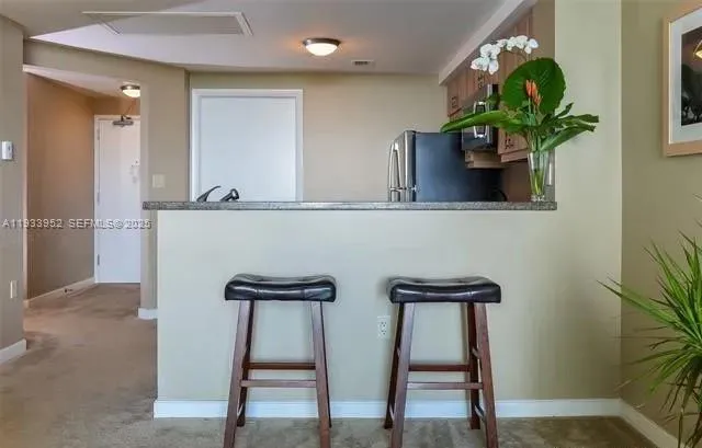 a vase of flowers sitting on a table near a window
