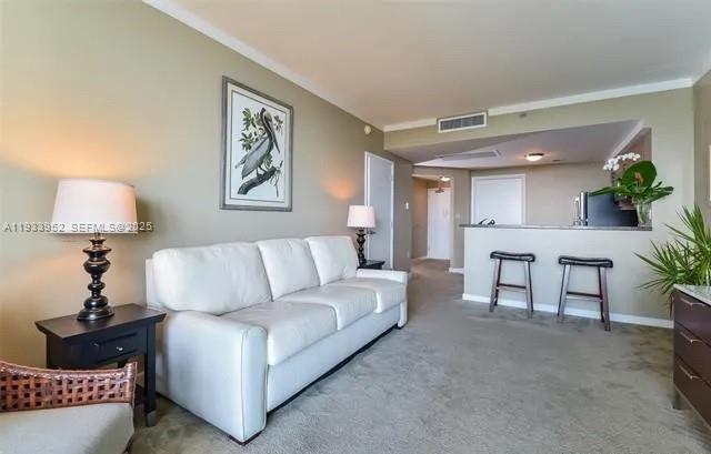 2889 McFarlane Road, Unit 1906 Miami, FL 33133 - Photo 8 of 9 a living room with furniture and a lamp