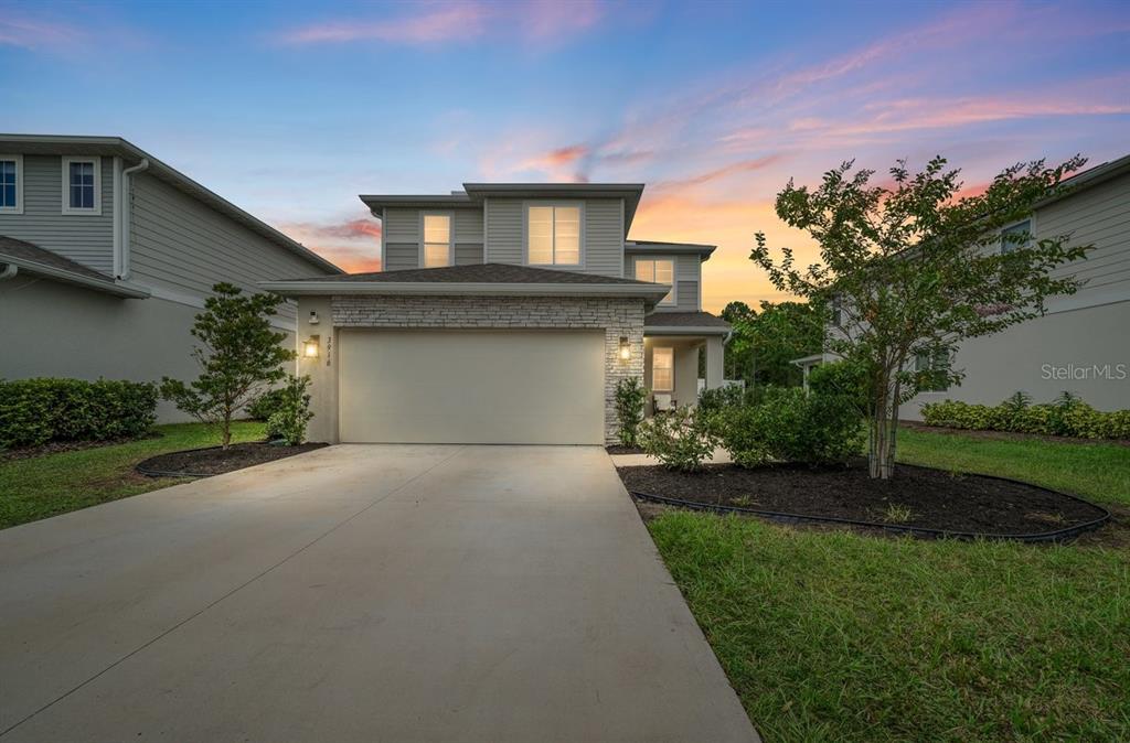 a front view of a house with a yard and garage