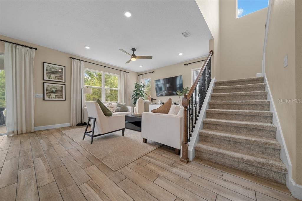 3916 Southern Vista Loop St. Cloud, FL 34772 - Photo 14 of 52 a living room with furniture and a wooden floor