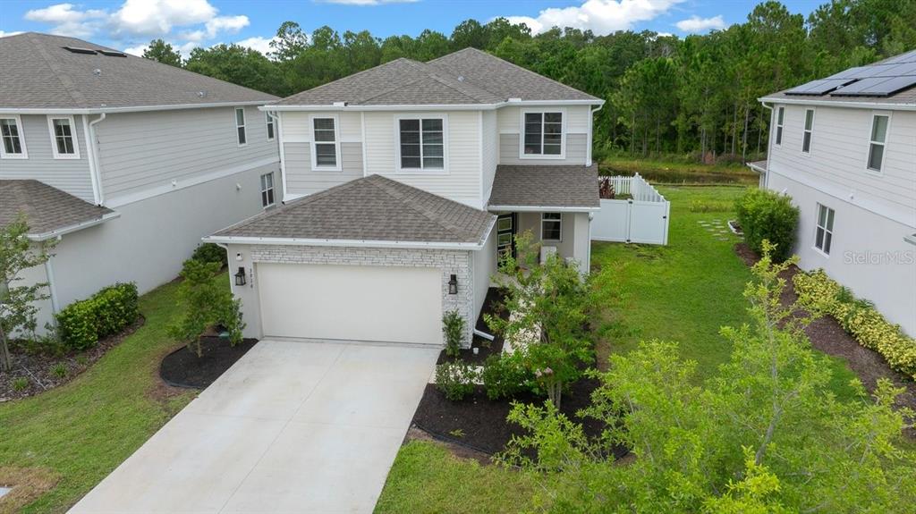 3916 Southern Vista Loop St. Cloud, FL 34772 - Photo 2 of 52 a front view of a house with a garden