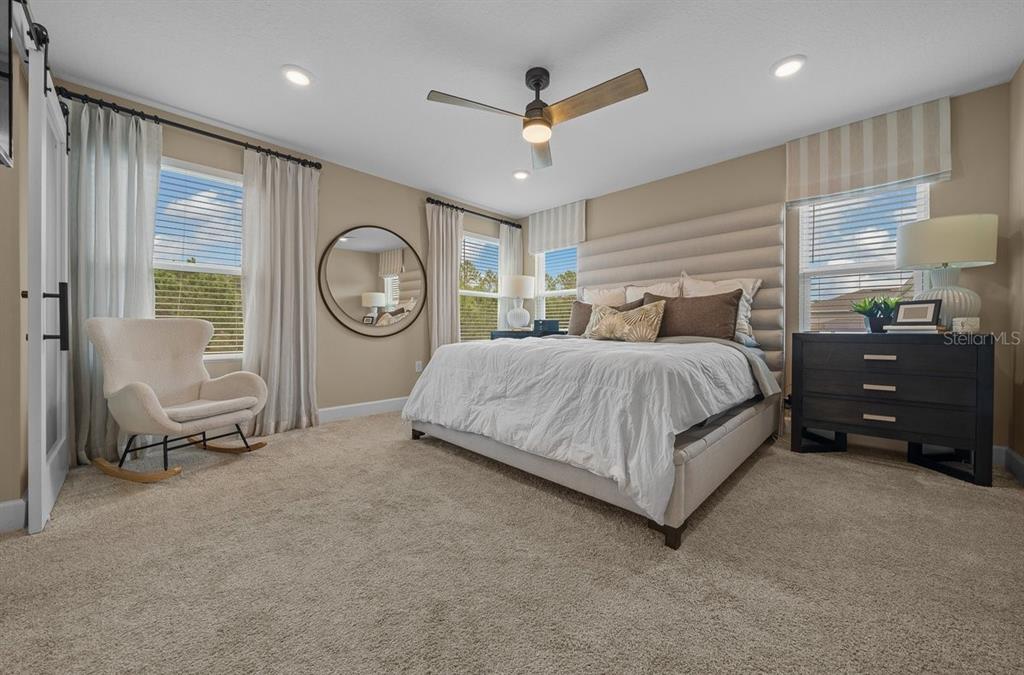 3916 Southern Vista Loop St. Cloud, FL 34772 - Photo 25 of 52 a bedroom with a bed a closet and a large mirror