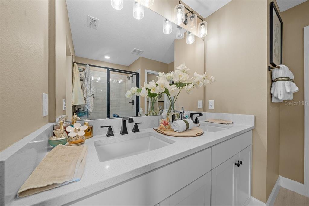 3916 Southern Vista Loop St. Cloud, FL 34772 - Photo 28 of 52 a bathroom with a sink double vanity and a mirror