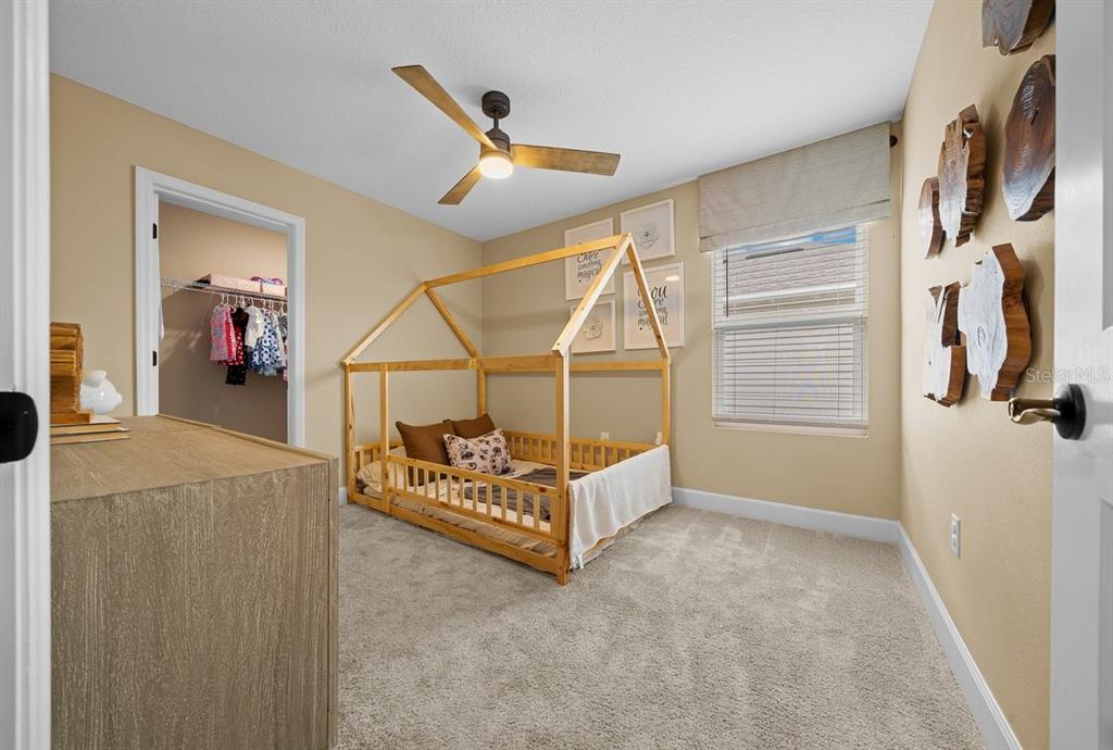 3916 Southern Vista Loop St. Cloud, FL 34772 - Photo 32 of 52 a bed room with a bed and a window