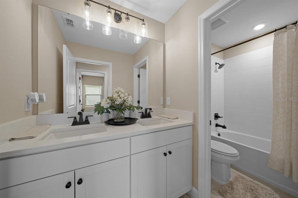 3916 Southern Vista Loop St. Cloud, FL 34772 - Photo 35 of 52 a bathroom with a sink a toilet and shower
