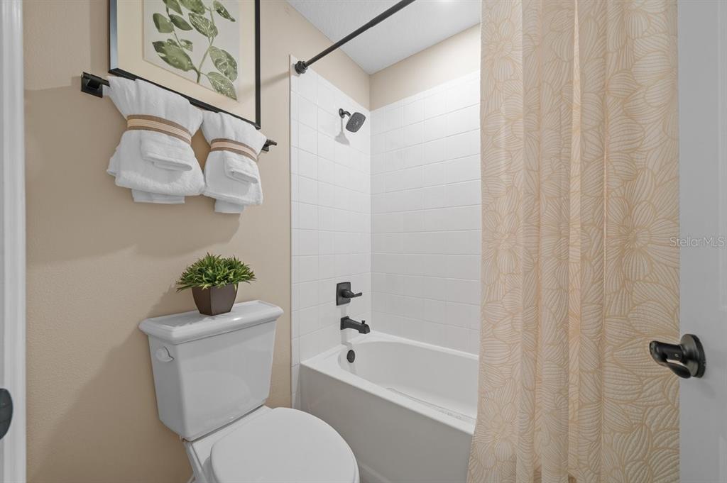 3916 Southern Vista Loop St. Cloud, FL 34772 - Photo 36 of 52 a white toilet sitting next to a bath tub