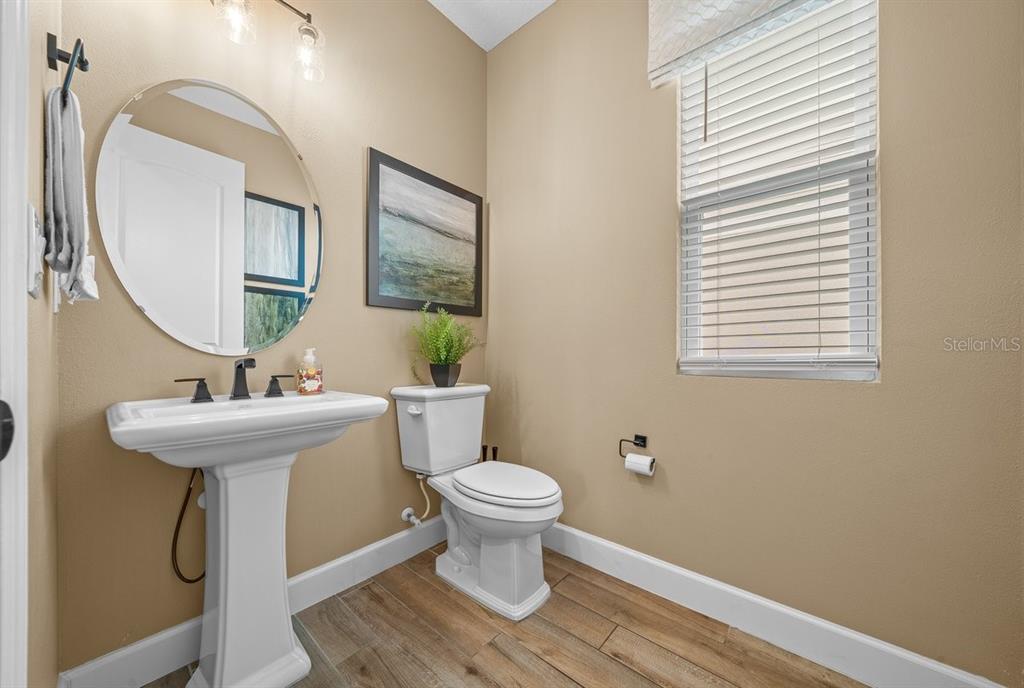 3916 Southern Vista Loop St. Cloud, FL 34772 - Photo 40 of 52 a bathroom with a toilet a sink and a mirror