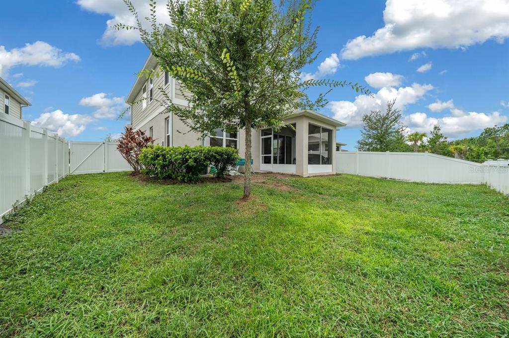 3916 Southern Vista Loop St. Cloud, FL 34772 - Photo 44 of 52 a front view of a house with garden