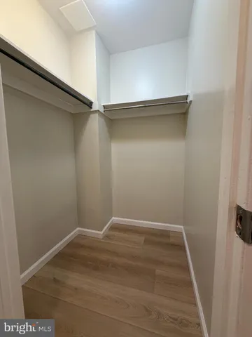 a bedroom with a bed and mirror