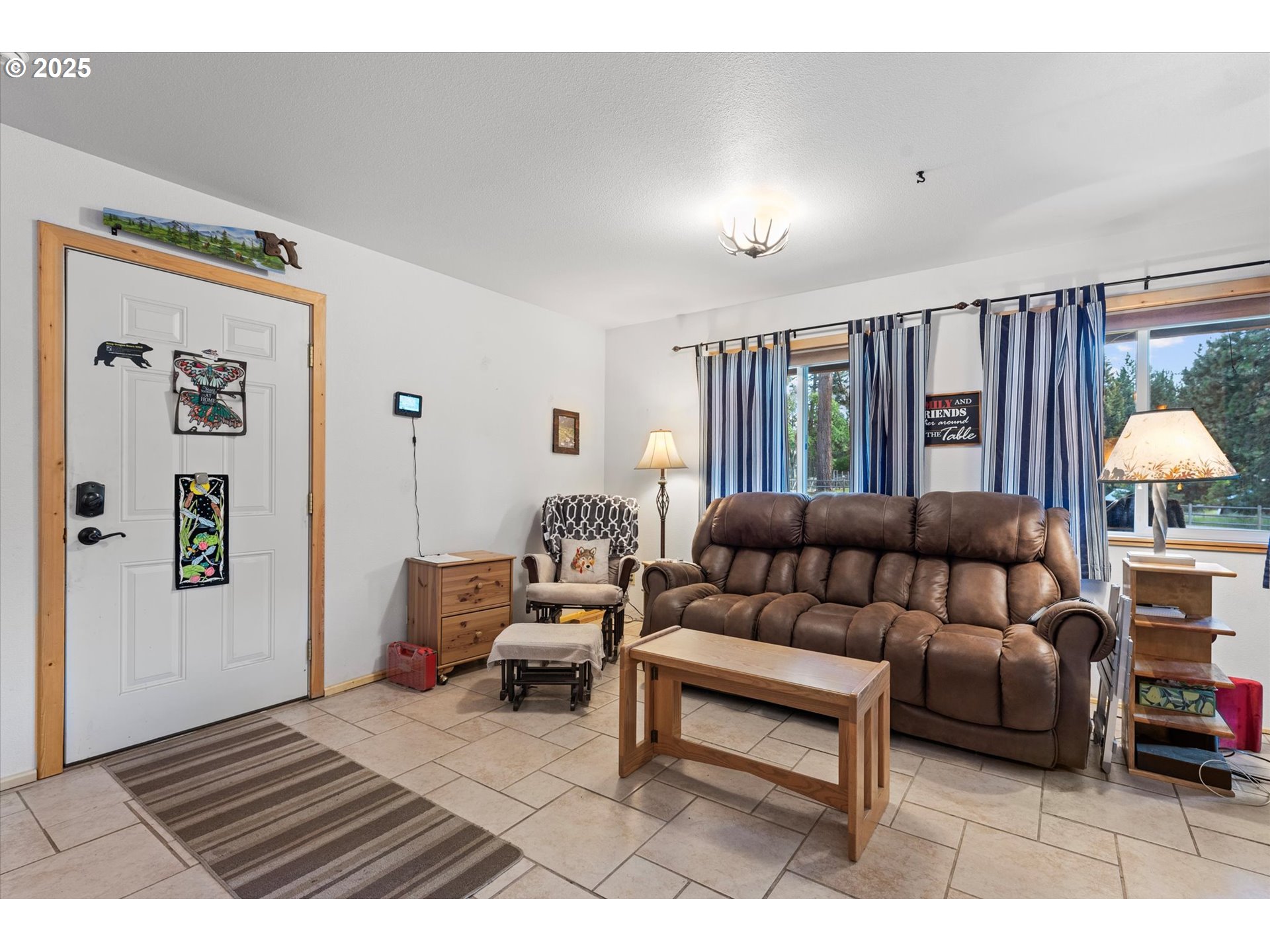 206 Austin Street Sumpter, OR 97877 - Photo 11 of 48 a living room with furniture a lamp and a large window