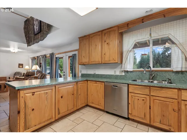 a kitchen with stainless steel appliances granite countertop a sink and cabinets