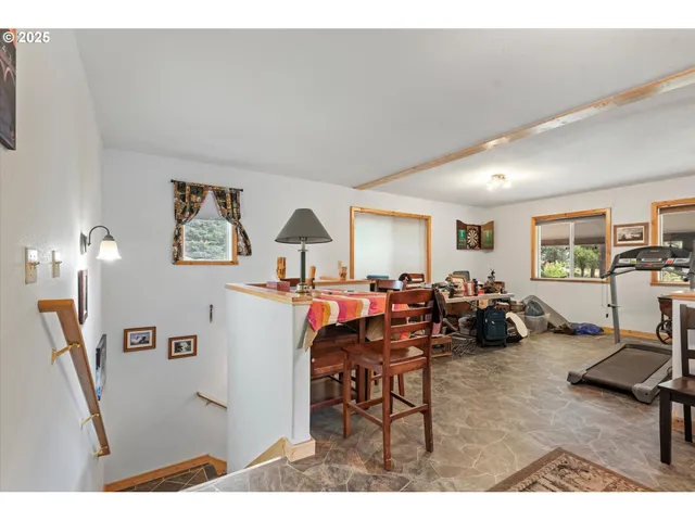 a living room with furniture a table and chair